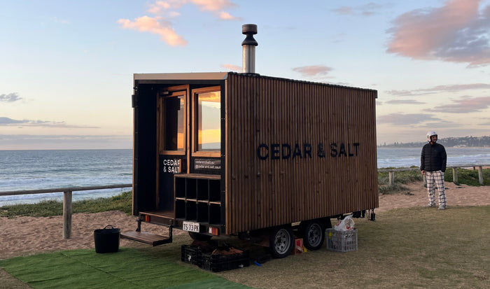 Beachside mobile sauna setup for hot and cold recovery sessions.